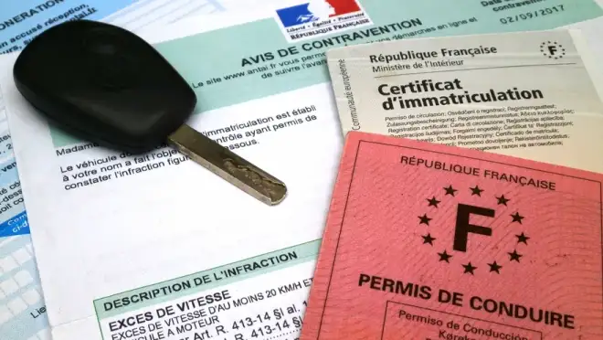 Certificat d'immatriculation posé sur une table avec des clés de voiture